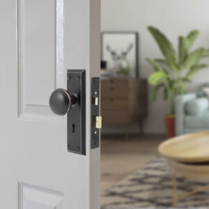 White painted internal house door partly open to show lock and handle